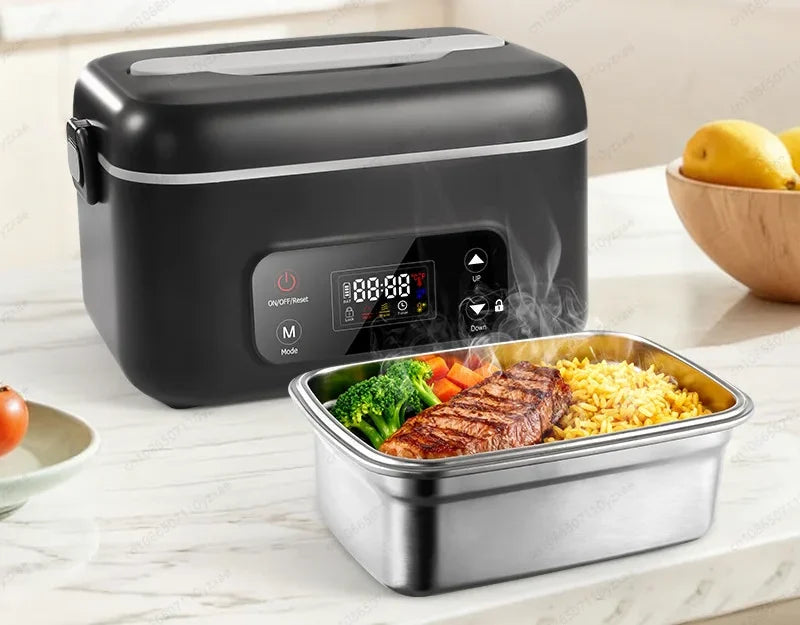 Dark grey electric lunch box beside its stainless steel pot filled with steak, rice and vegetables