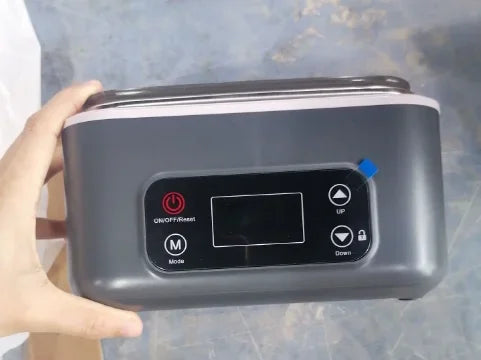 Lunch box held in one hand, showing its size